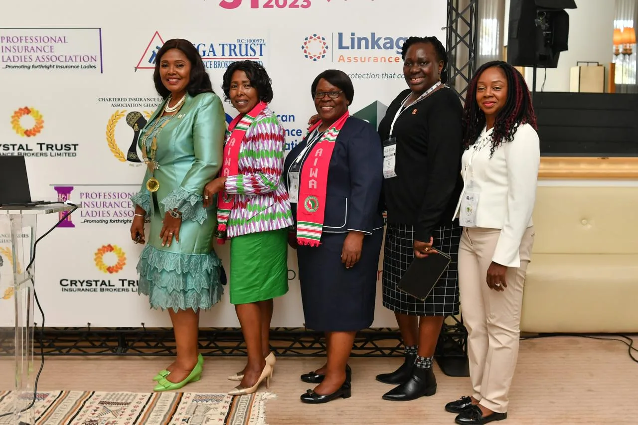 Five delegates standing in front of the partner banner at the investiture