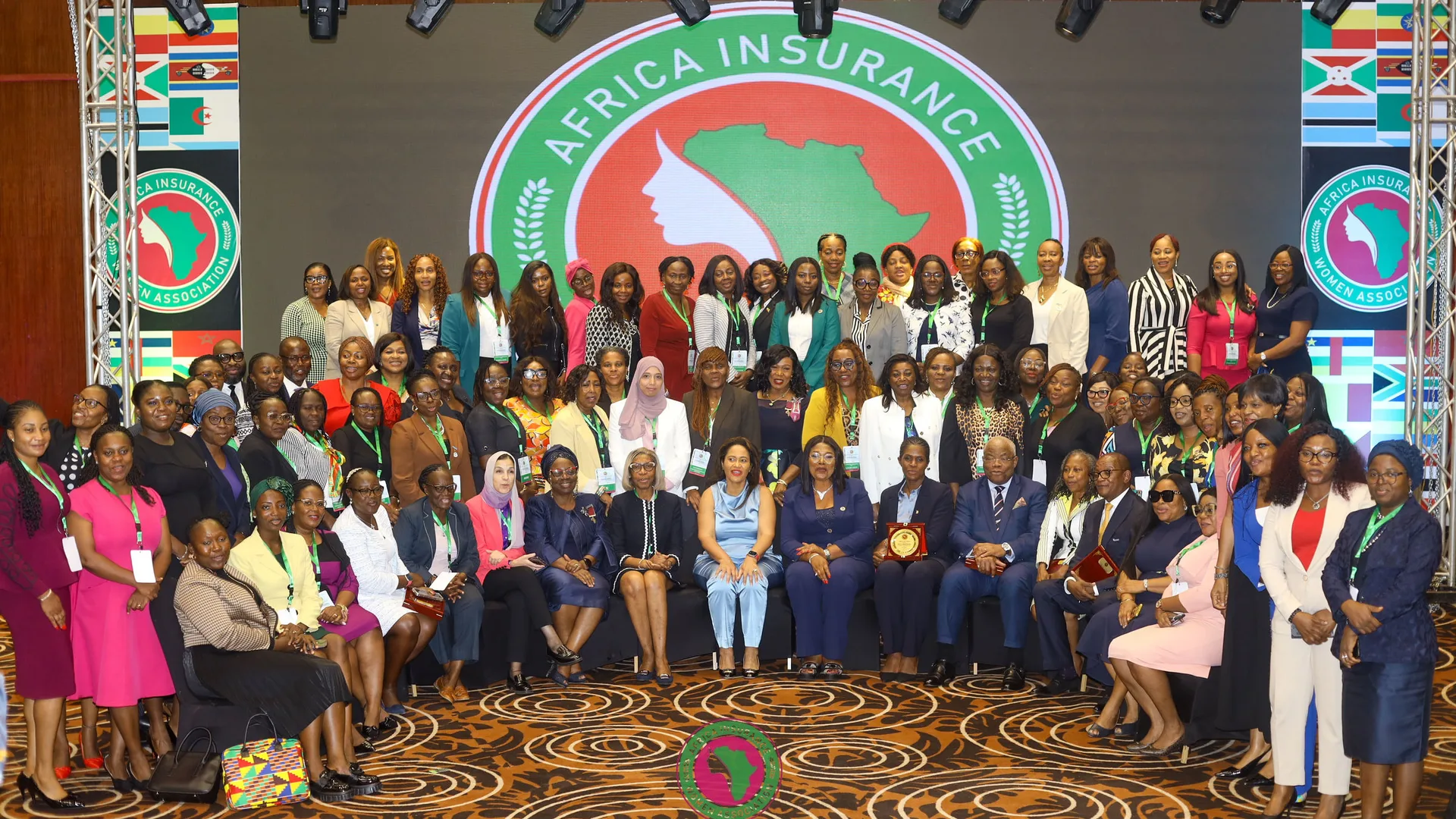 AIWA members gathered on stage beneath the association’s emblem, with national flags on banners at either side